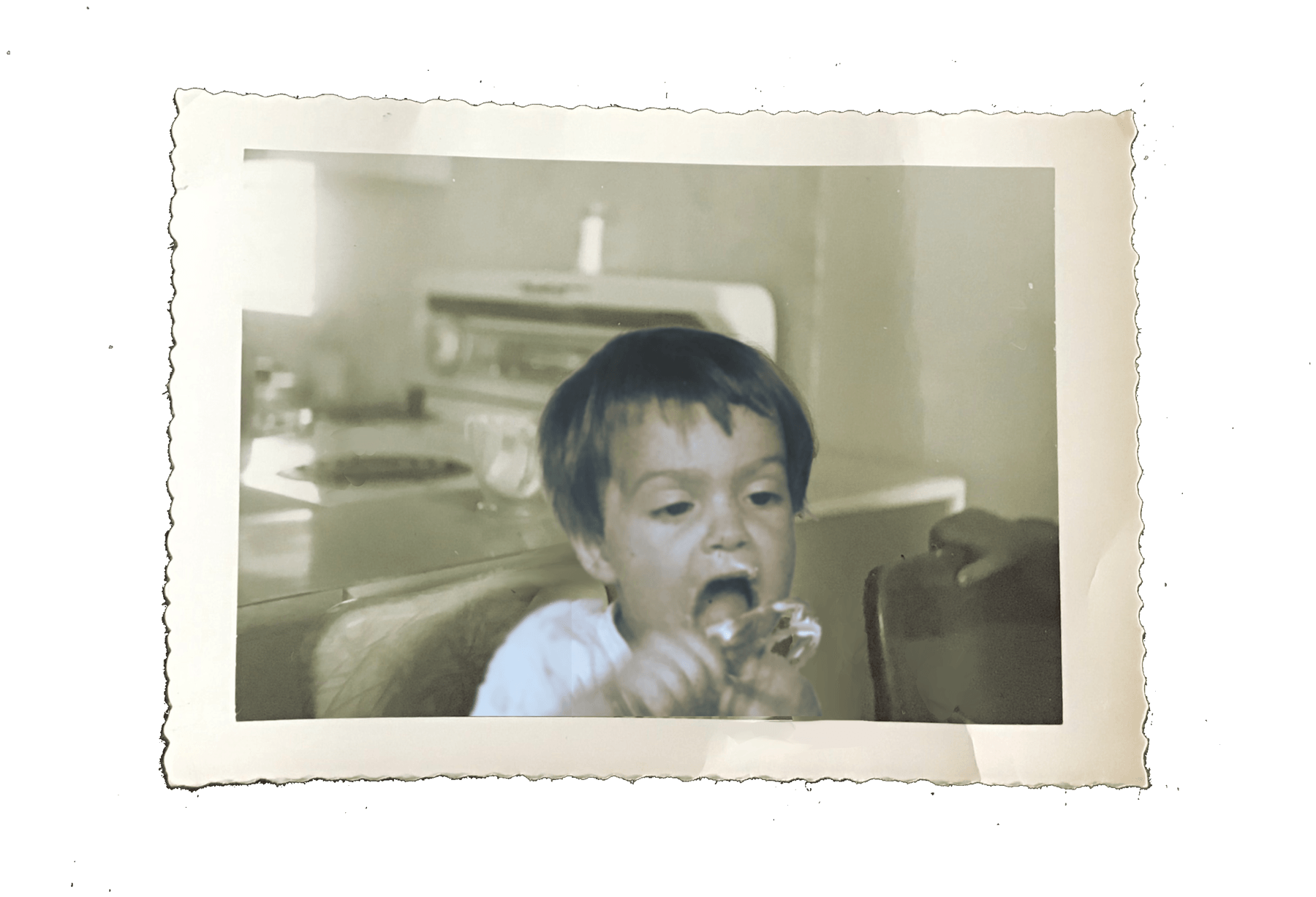 A vintage photo of young Annie in the kitchen, with the family's fridge and stove behind her